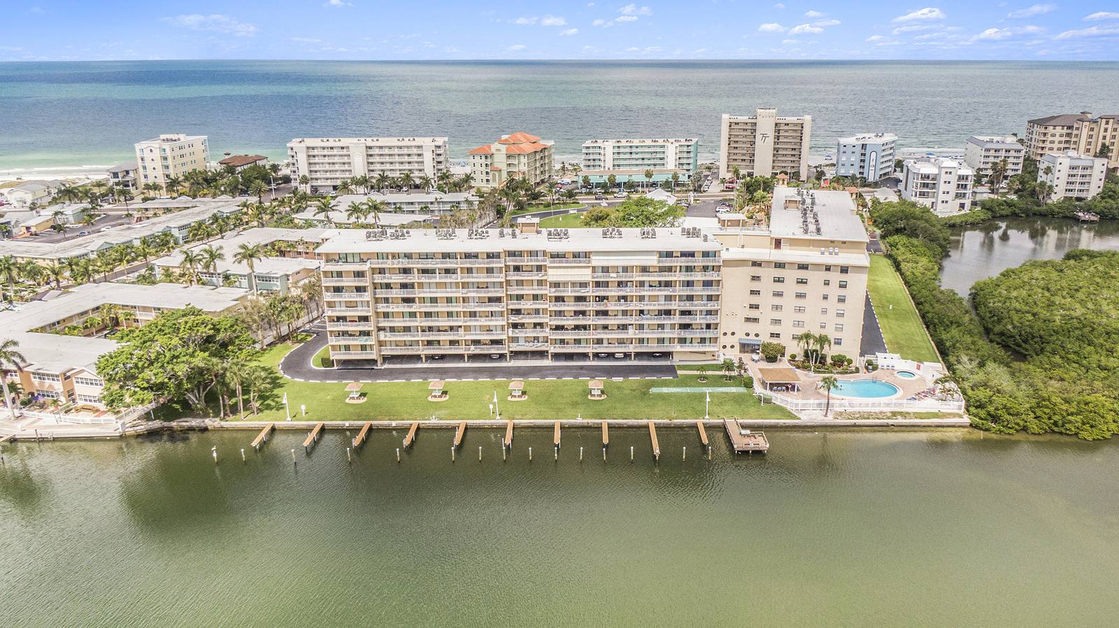 Aerial view of a waterfront condo community near the Gulf beaches